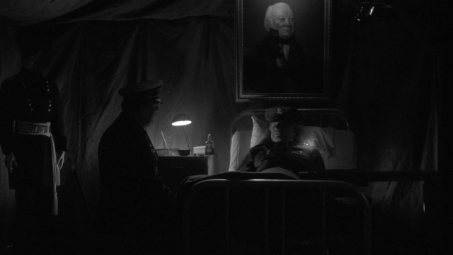 Meanwhile, a random (and low tier) shot of Toys actually reveals more info in black and white. Notice how the uniform insignia is lit. I would bet money the shoulder of the lying man was intentionally lit with its own light. Without color you still get that the man in the painting is of great importance to the man in bed.