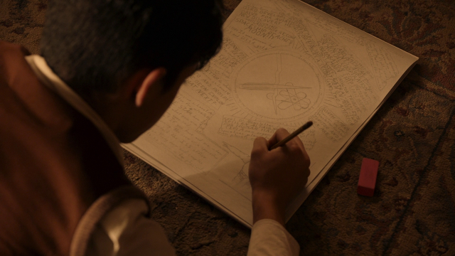 Shot of Cosmos: Possible Worlds. Young boy drawing the figure described in the next shot.